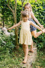 JKB's daughters wearing the Lila pinafore dress in Navy and Yellow print. 