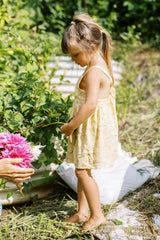 Yellow floral girls dress with gathered skirt. 