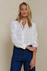 Sleeve gathering detail on white broderie blouse