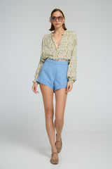 Relaxed fit floral shirt styled with high-waisted shorts
