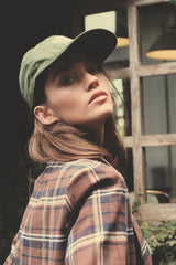 Jungle Green cap paired with relaxed autumn layers