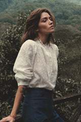 Romantic white blouse styled with soft frill neckline