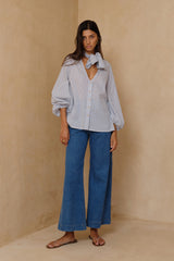 Mid blue denim jeans styled with oversized shirt for relaxed everyday dressing