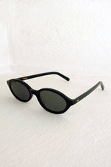 Black sunglasses on a textured white background