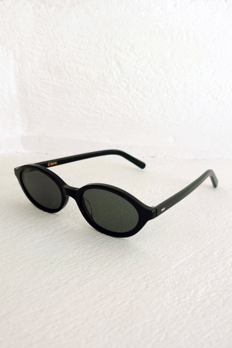 Black sunglasses on a textured white background