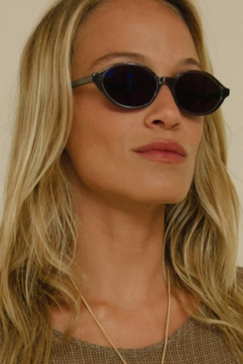 Woman wearing round sunglasses by Cove and Maison Mata