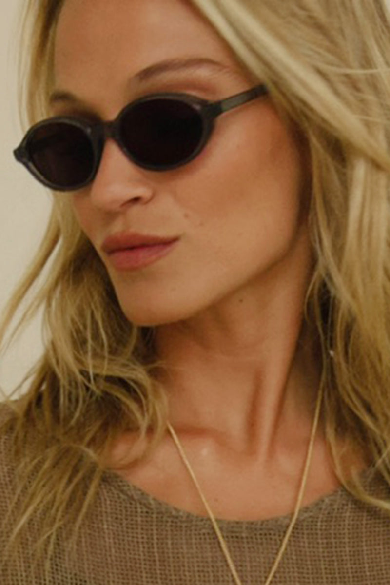 Side view of black sunglasses by Cove and Maison Mata