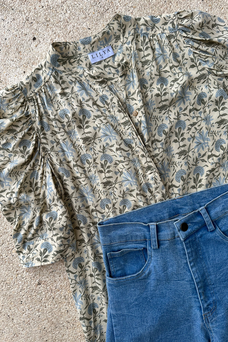 A flatlay image of the Woodford Blouse floral print by Lilya