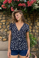 Model wears a peplum short sleeve top with floral print by LILYA.