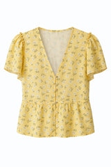 Ghost image of the Monty Top with a peplum hem in a yellow floral print for summer. 