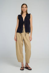 Model wearing LILYA Jupiter Lace Top in navy cotton with lace trim details and tie front styling