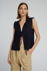 Sleeveless navy cotton lace top styled casually with relaxed utility pants