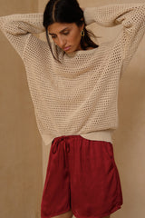 Soft open-weave knit sweater with dropped shoulders and relaxed silhouette