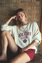 Relaxed cotton sweater styled casually with tailored shorts