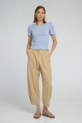 Model wearing LILYA Raincloud Top in pale chambray stripes paired with relaxed sand Utility Pants.