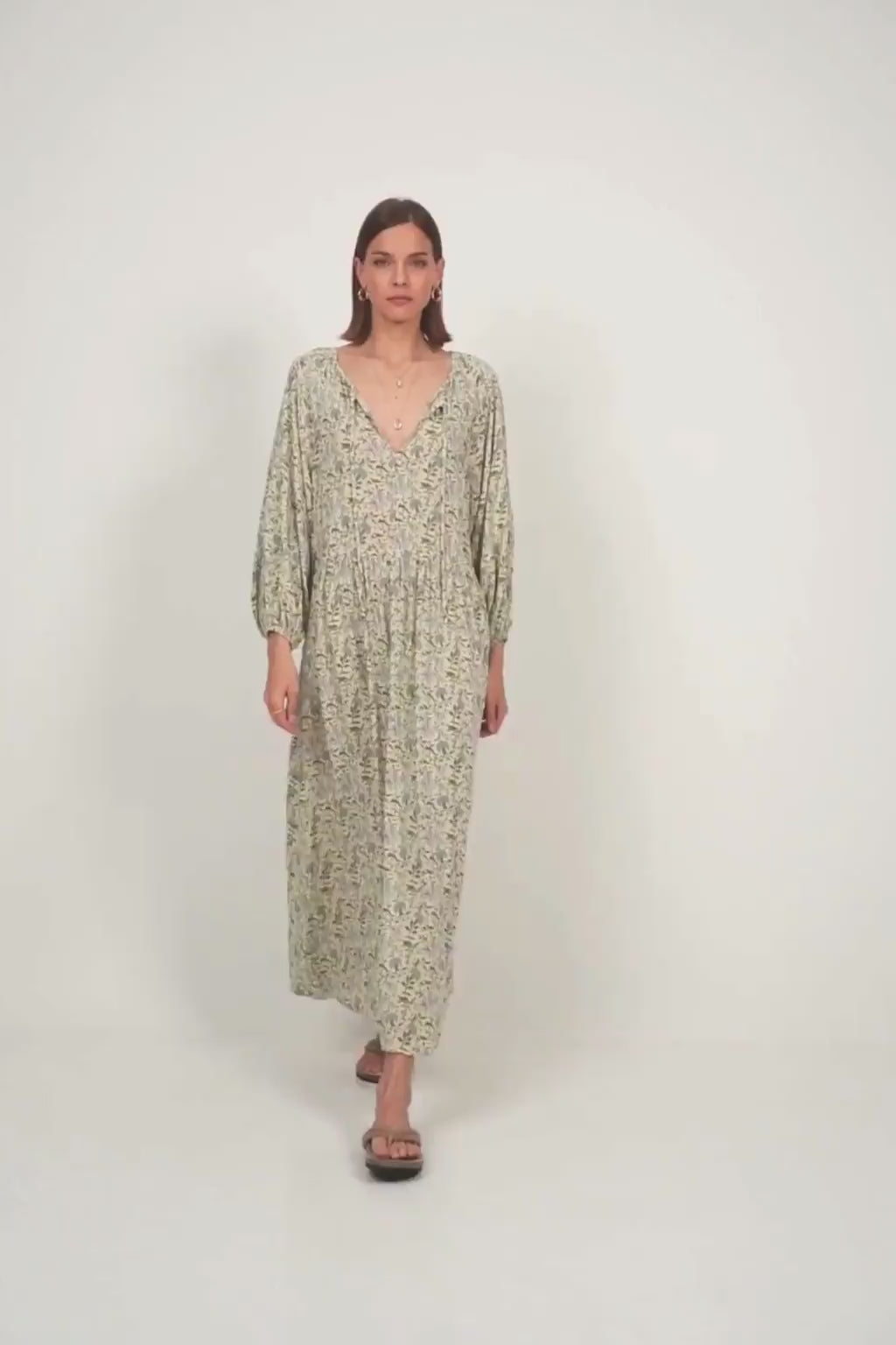 Model in relaxed fit floral dress with billowy sleeves and bohemian charm