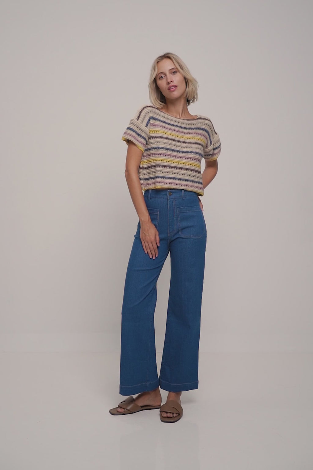 A model wearing a cropped striped casual knit top