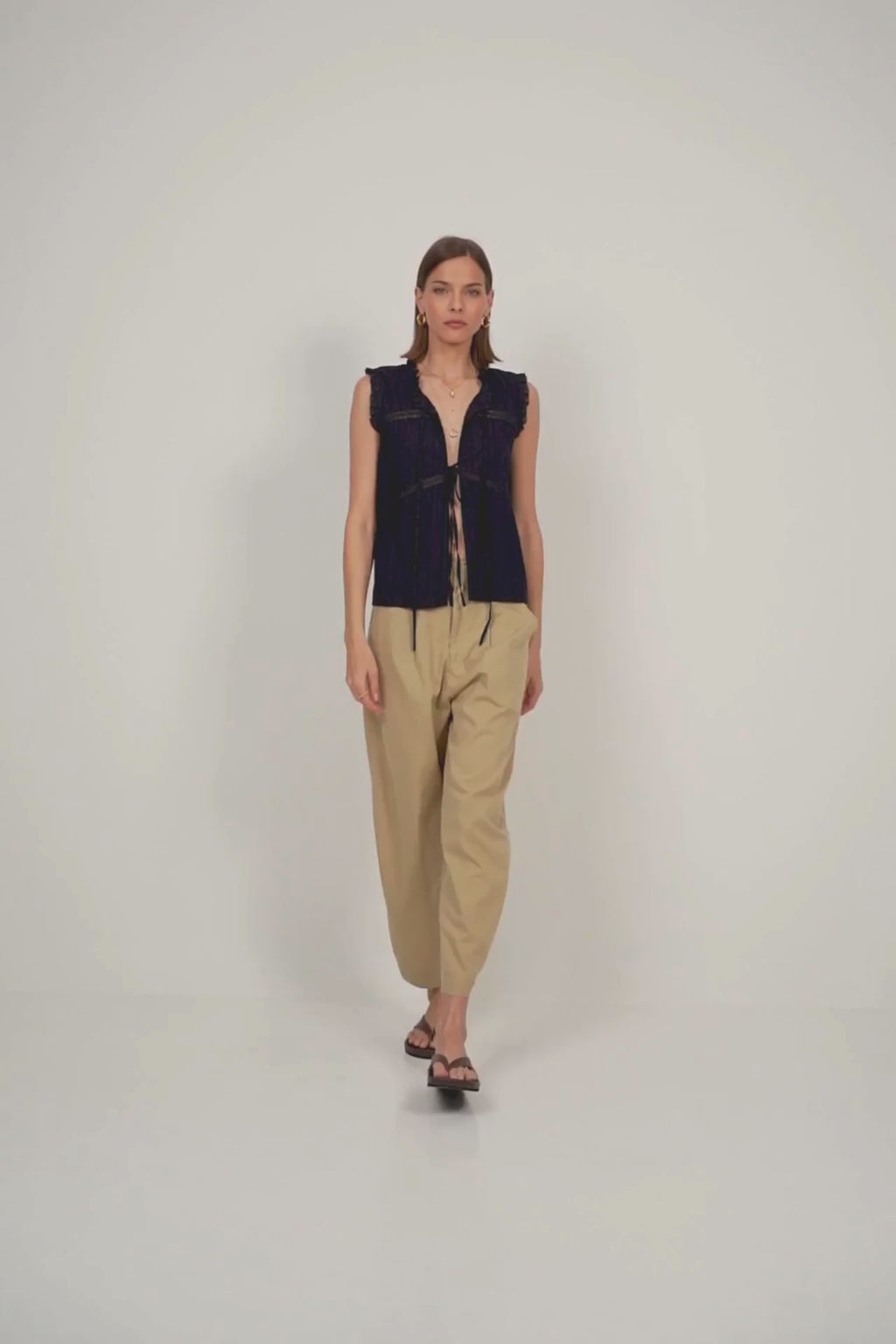 Navy sleeveless lace-trimmed cotton top paired with sand utility pants for effortless summer style