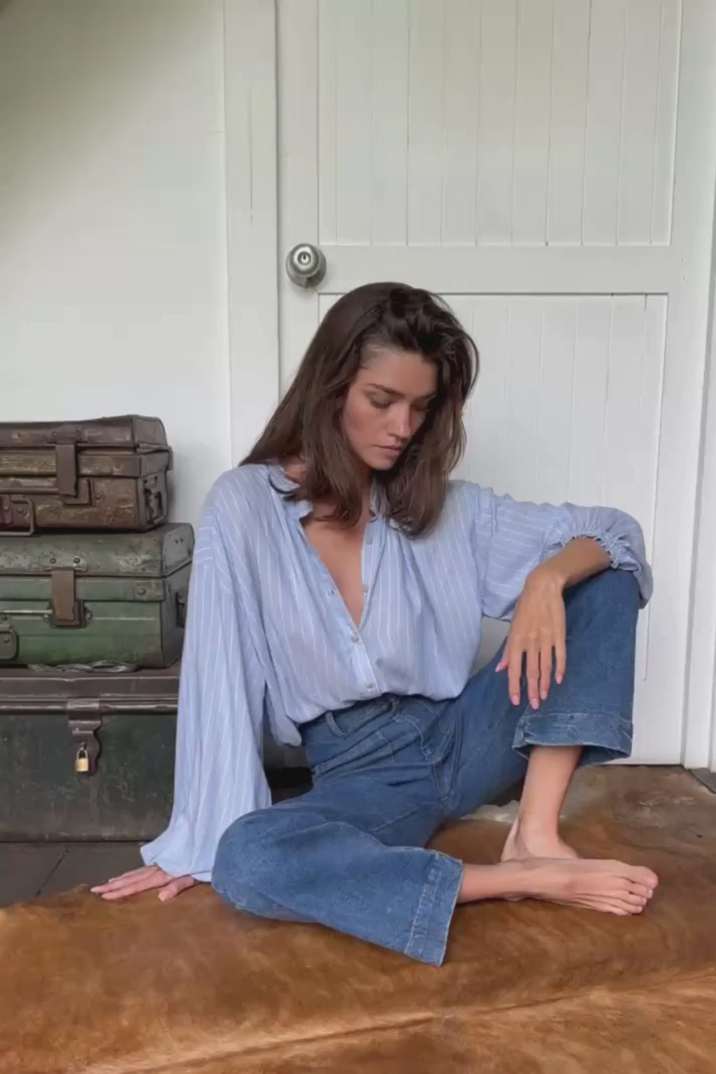 detail video showing blue stripe shirt with elastic cuffs sleevs and frill neckline with vintage look jeans