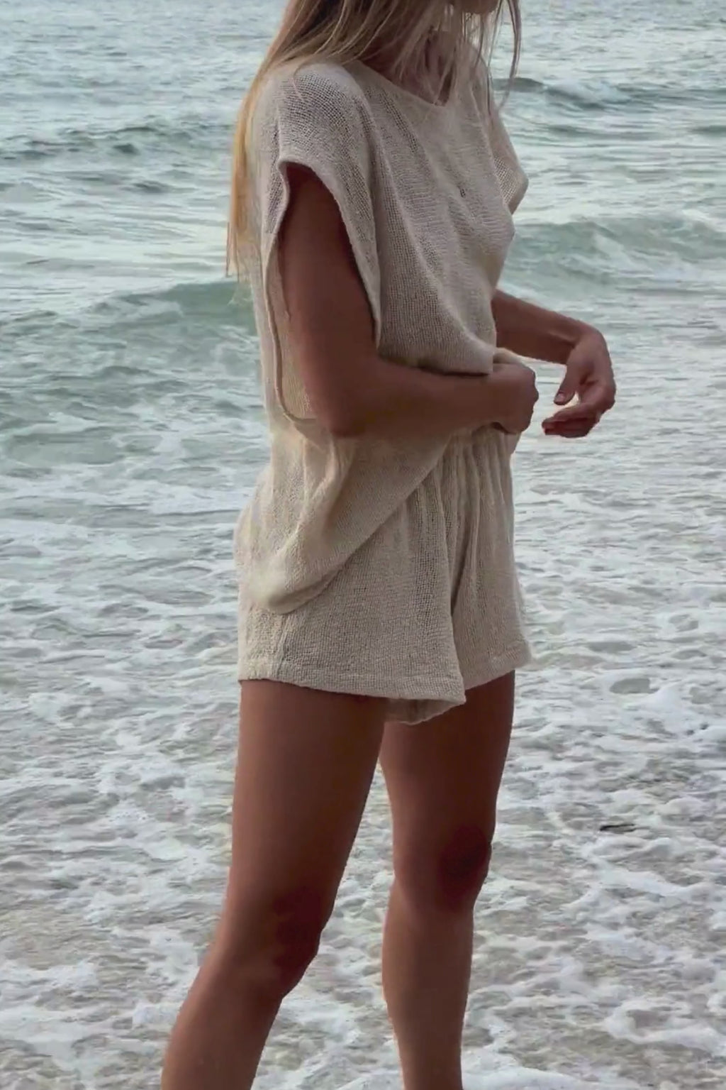 Women’s cotton mesh shorts styled with a simple tank on the beach 