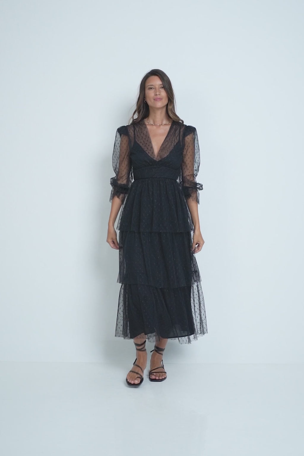 A model wearing an elegant black lace maxi dress
