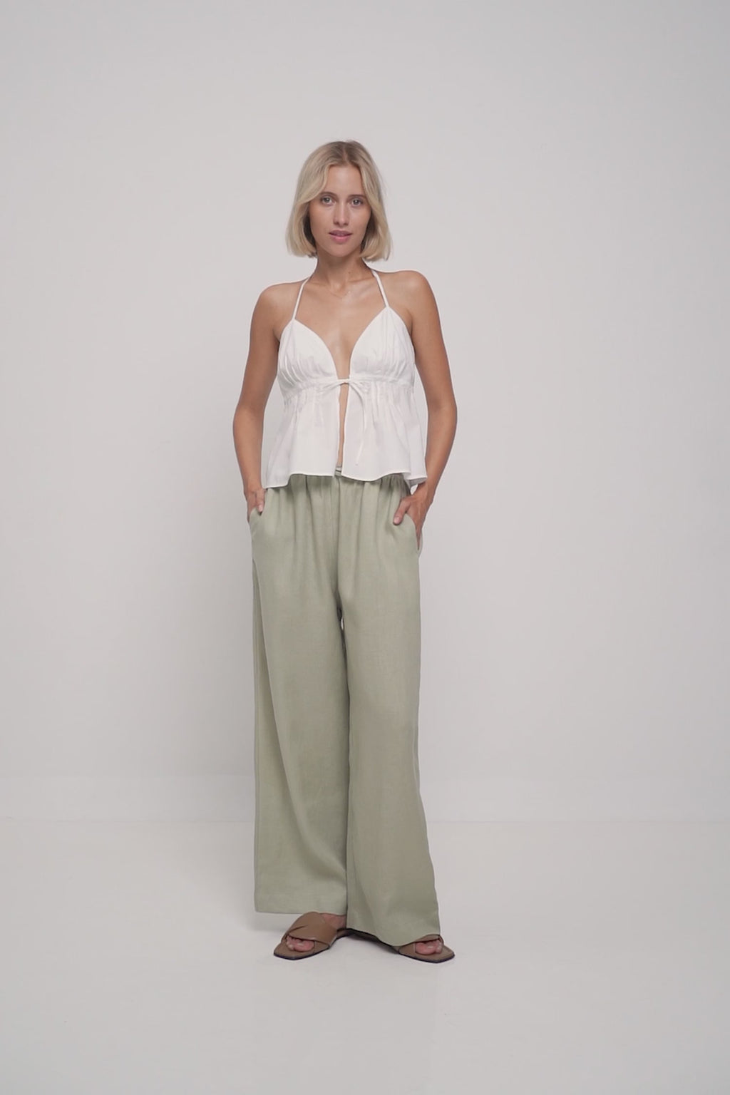 A model wearing casual green linen beach pants