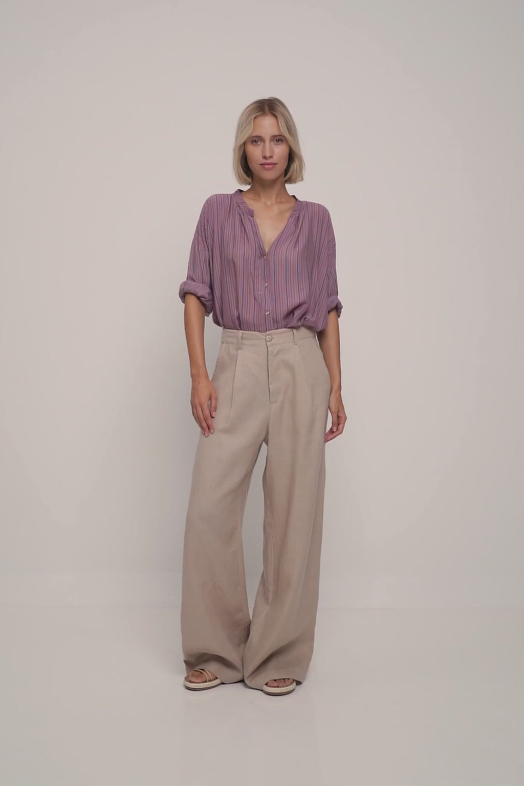 A model wearing a purple stripe casual blouse