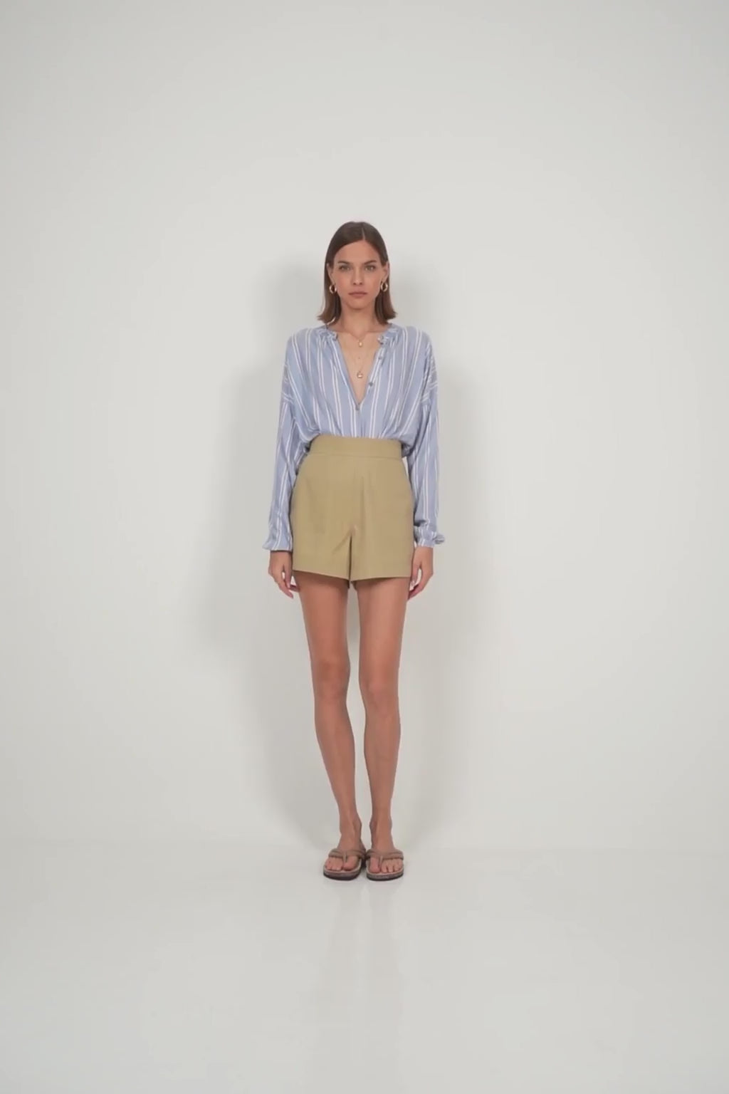 A model wearing neutral coloured A-line shorts