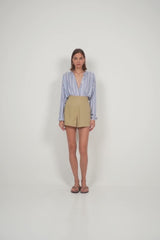 A model wearing neutral coloured A-line shorts