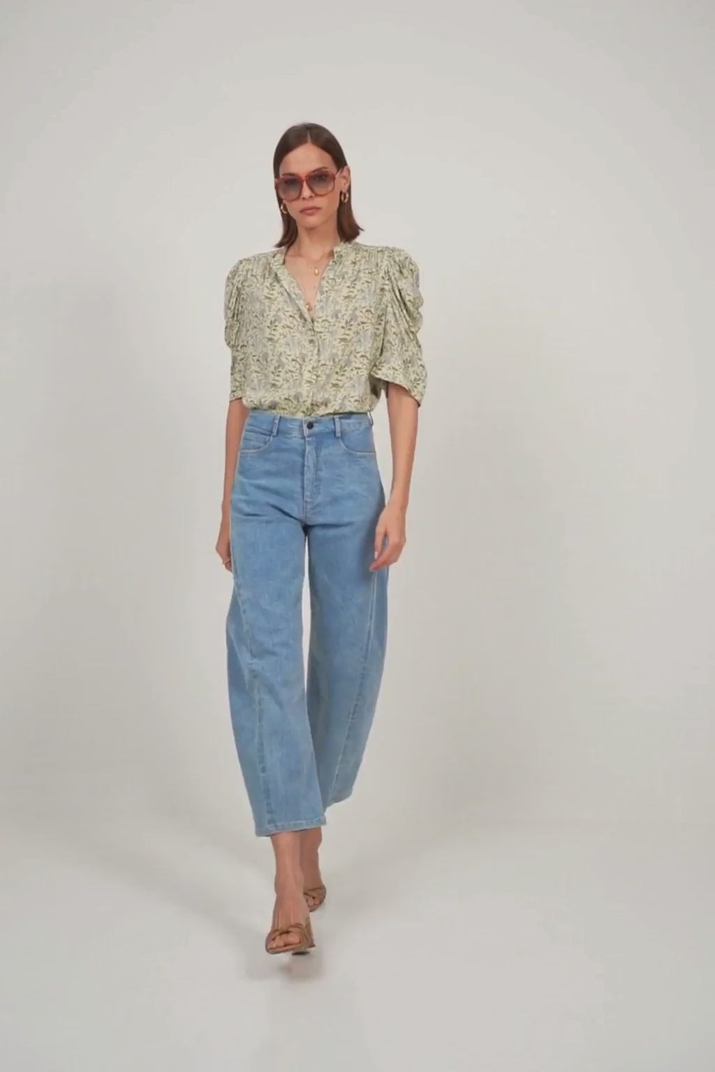 A model wearing a feminine floral top 