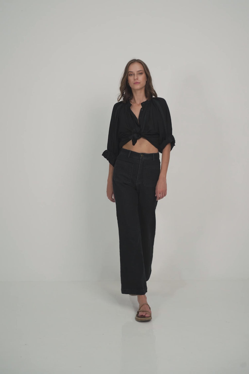 A Model Wearing a Loose Classic Black Summer Blouse
