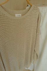 Neutral knit sweater styled casually for warm evenings and layering