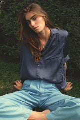 Close up of navy long sleeve soft blouse