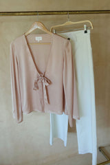 Styled on a rack an easy satin blouse for dinner, travel and everyday wear with white jeans