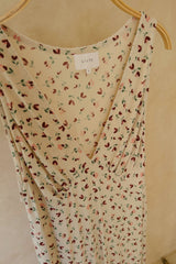 Rack image of feminine midi dress with lightweight fluid movement with picot trim on neckline