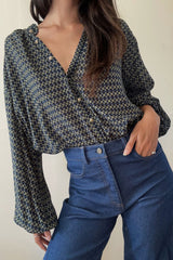 Girl wearing blouse with bell sleeves styled with denim jeans