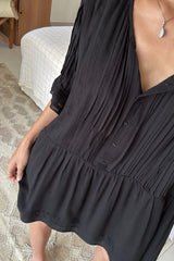 Black oversized Sonora Mini Dress with pintuck detailing, button-through front and three-quarter frill sleeves.