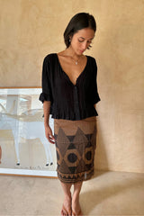 Woman wearing the black Sonora Top styled with black sarong for summer styling.