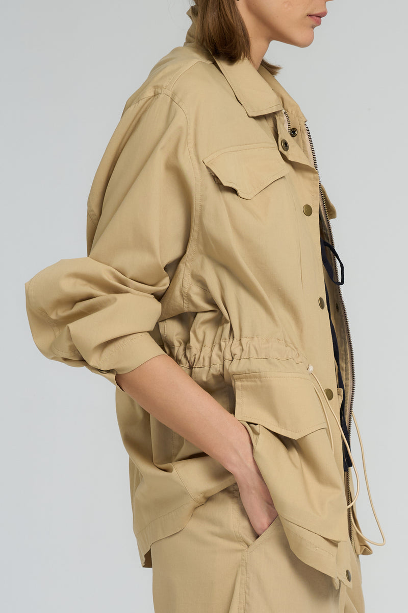 Relaxed cotton sand utility jacket with drawstring waist and flap pockets by LILYA.