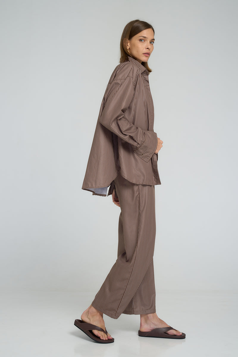 Relaxed fit button-up shirt featuring contrasting panels and a scooped hemline