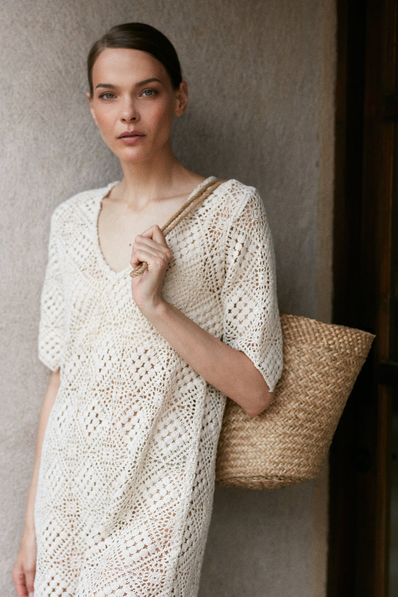 A model wearing a rattan bag with Nava Dress