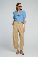 Sand-colored utility cotton pants with ankle press-stud closures