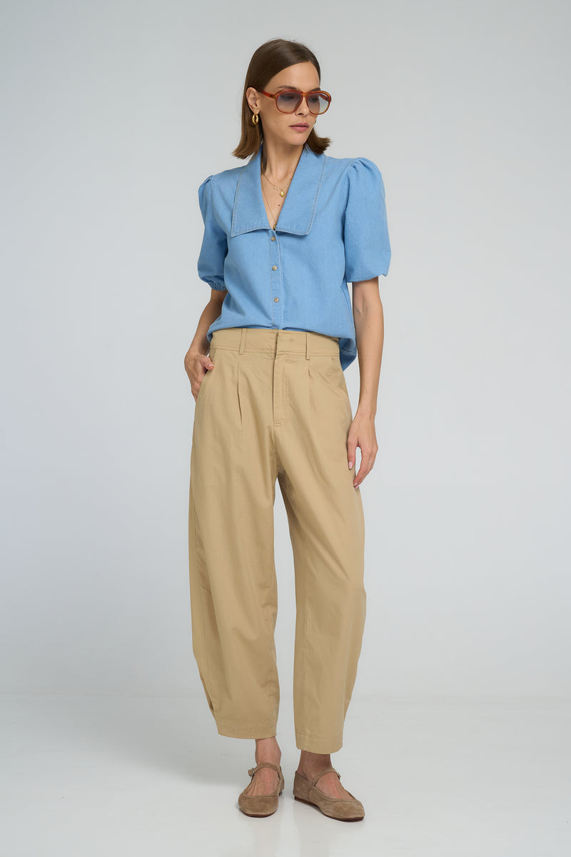 Sand-colored utility cotton pants with ankle press-stud closures