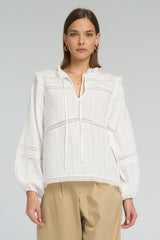 Romantic vintage-inspired cotton blouse with lace detailing and soft V-neckline
