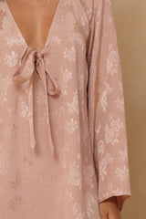 Jacquard mini dress featuring woven rose texture and tie neckline 
