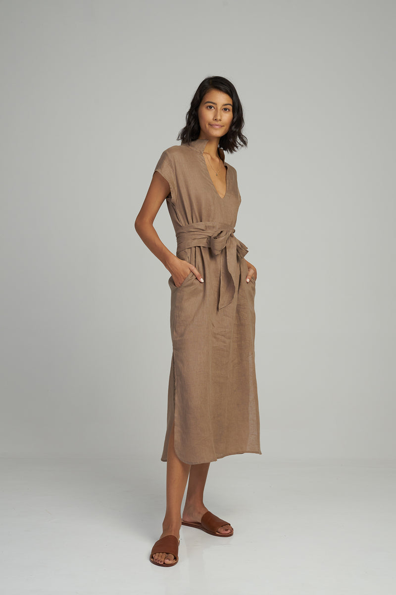 A woman wearing a Palma Linen Maxi Dress by Lilya