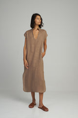A woman in a summer linen maxi dress by Lilya